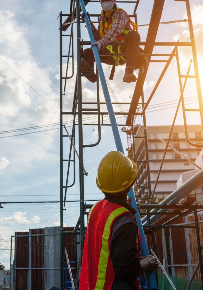 Michigan construction workers on a job site with a MiOSHA representative. 