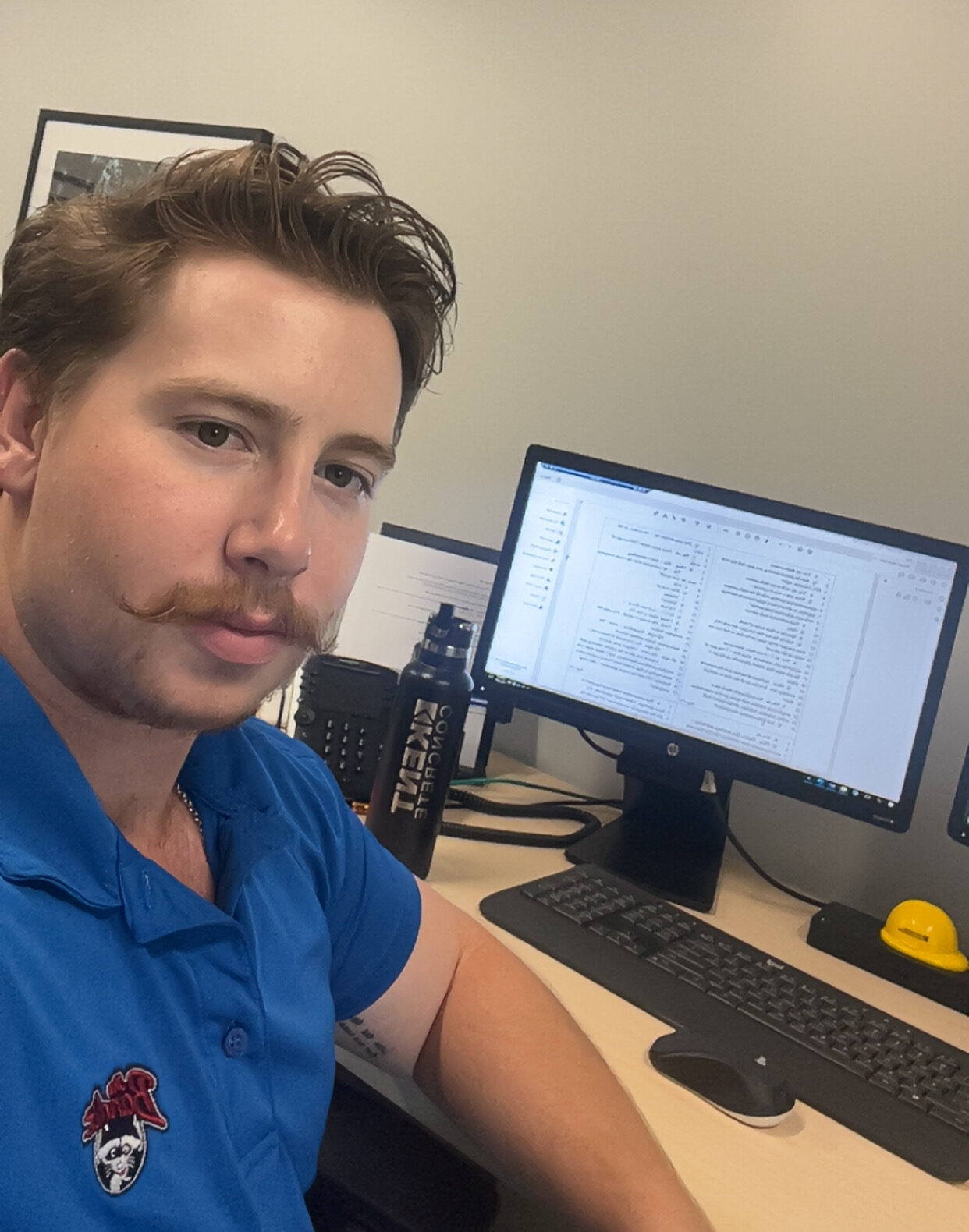 Intern Tyler Penlerick sitting at his desk in the Hilger Hammond office.