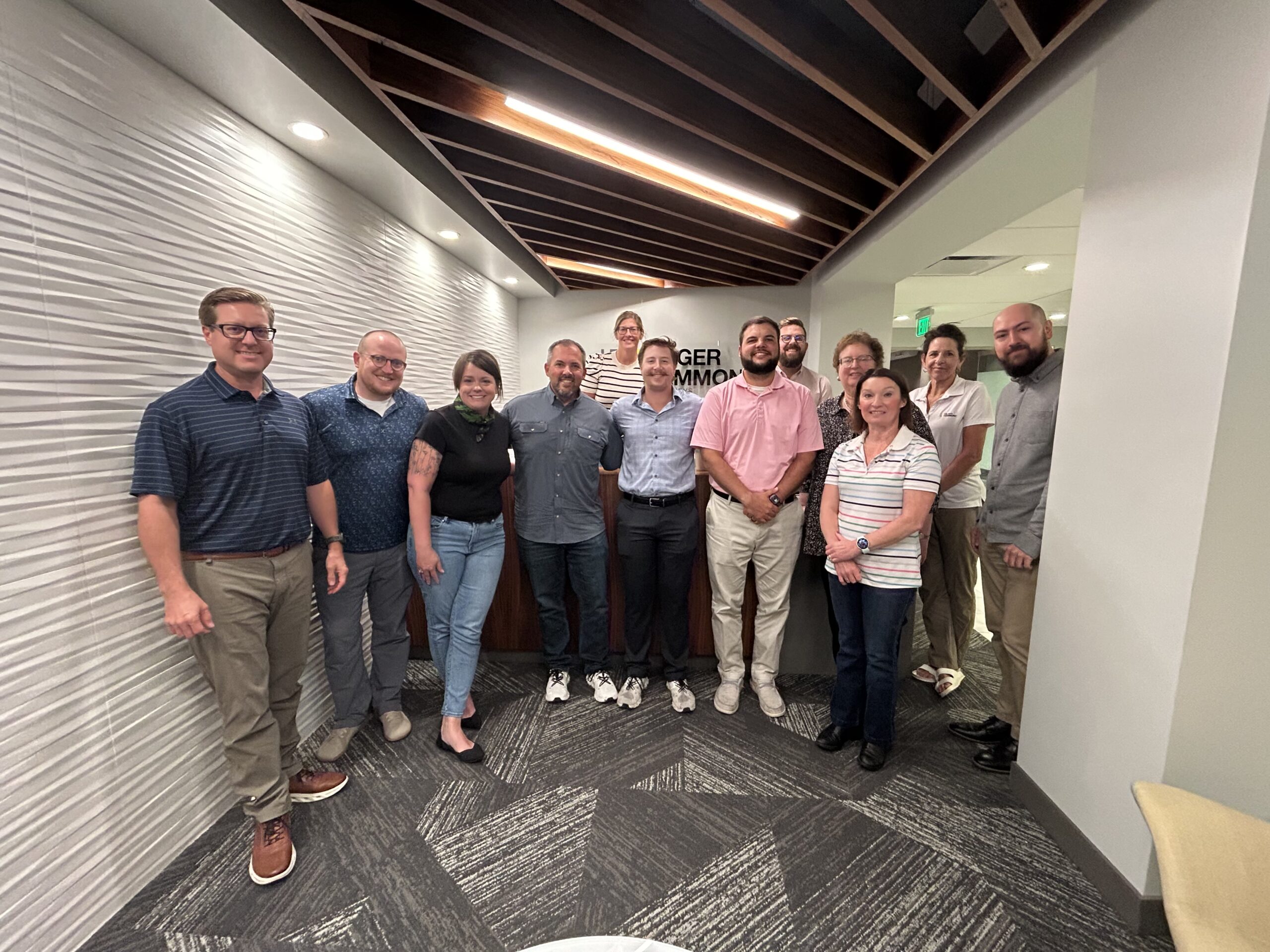 The Hilger Hammond team takes a picture with Tyler Penlerick and his father on his final day of his internship at Hilger Hammond.