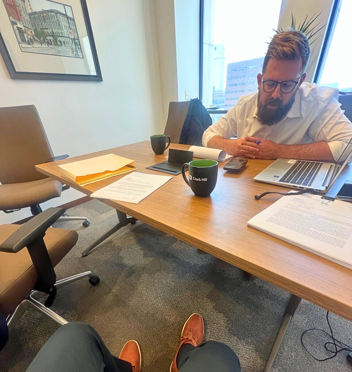 Hilger Hammond attorney Chad Antuma working with Tyler Penlerick in his office.