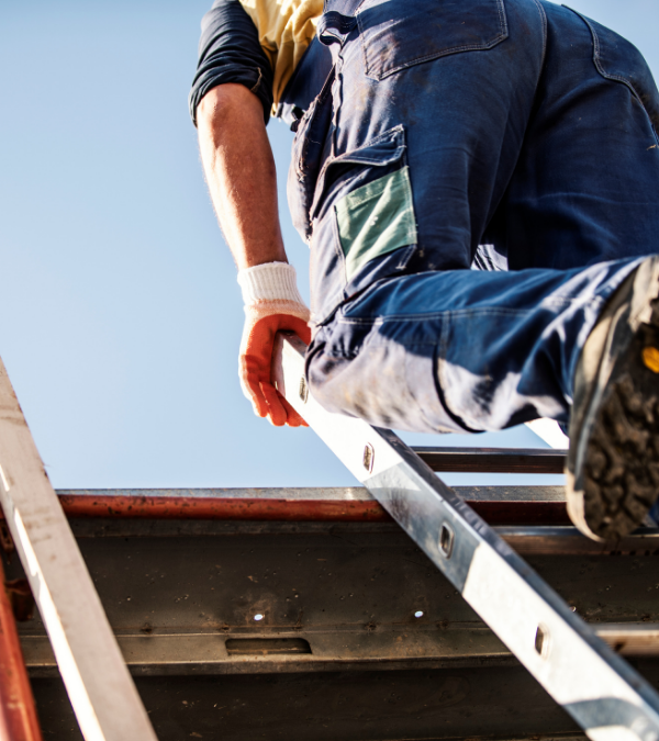 A construction worker is climbing a ladder on a job site without the proper safety precautions - in danger of incurring a MIOSHA citation.